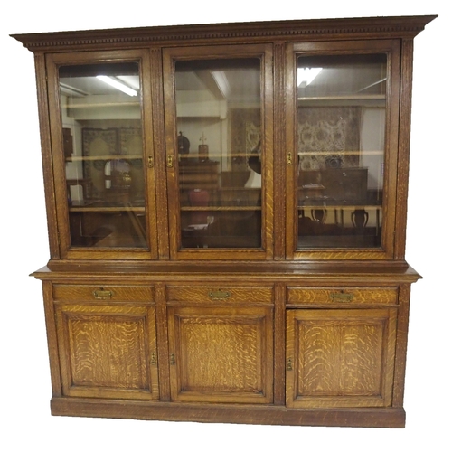 819 - An Edwardian oak three door bookcase