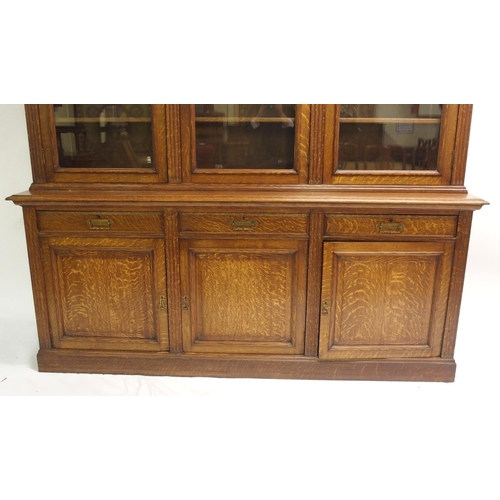 819 - An Edwardian oak three door bookcase