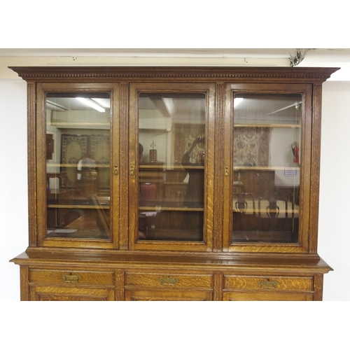 819 - An Edwardian oak three door bookcase