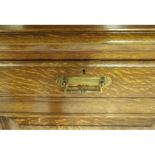 819 - An Edwardian oak three door bookcase