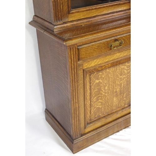 819 - An Edwardian oak three door bookcase