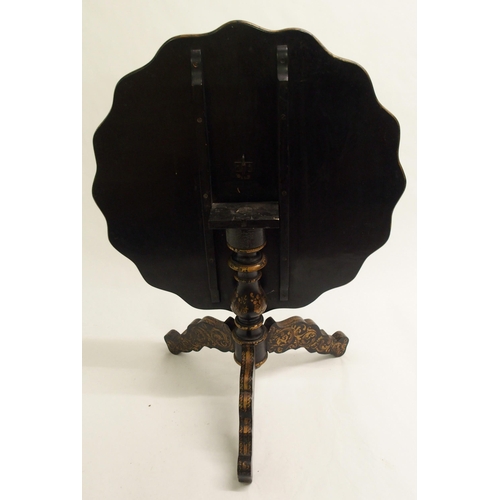 826 - An ebonised tripod table