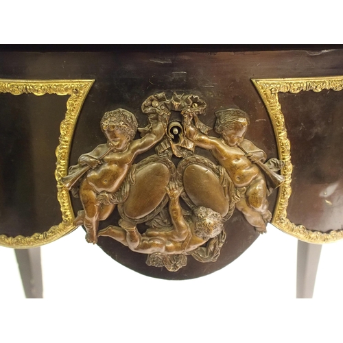 834 - A Louis XV style ebonised and gilt metal oval shaped centre table