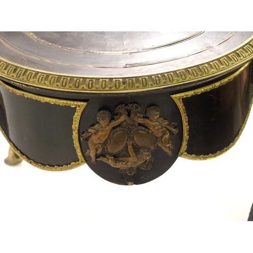 834 - A Louis XV style ebonised and gilt metal oval shaped centre table