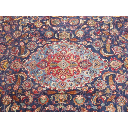 888 - A blue ground meshed rug