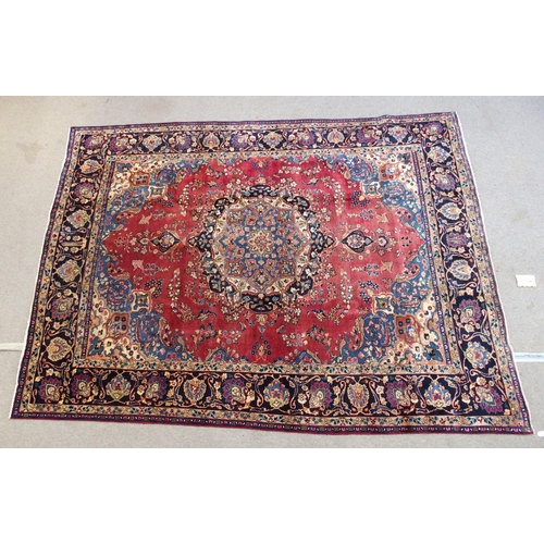 889 - A red ground meshed rug