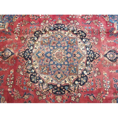 889 - A red ground meshed rug