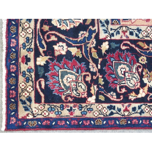 889 - A red ground meshed rug