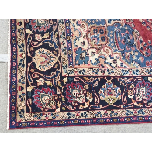 889 - A red ground meshed rug