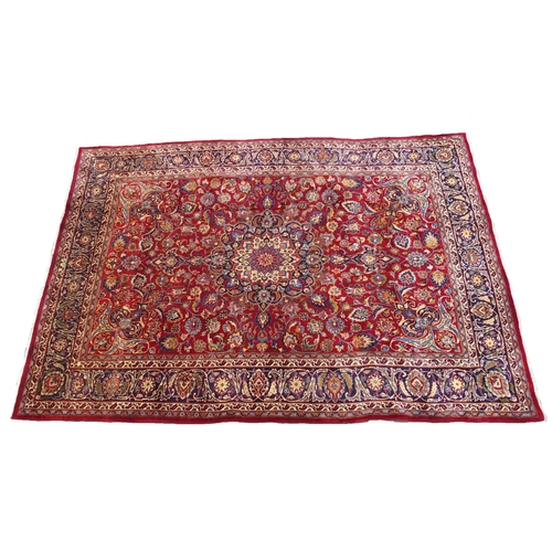 891 - A red ground meshed rug