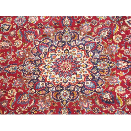 891 - A red ground meshed rug