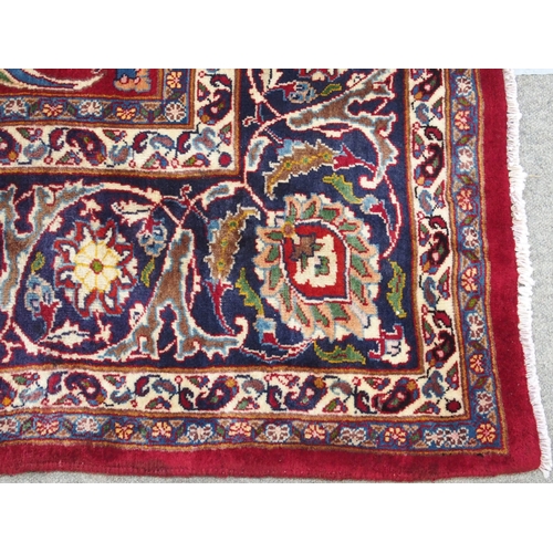 891 - A red ground meshed rug