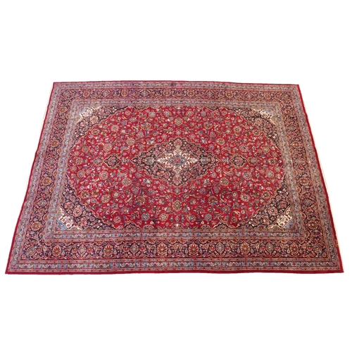 895 - A red ground Kashan rug