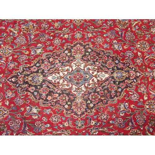 895 - A red ground Kashan rug