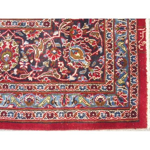 895 - A red ground Kashan rug