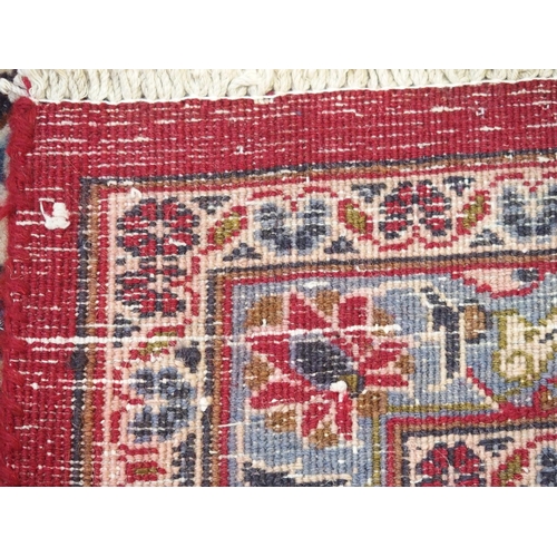 895 - A red ground Kashan rug