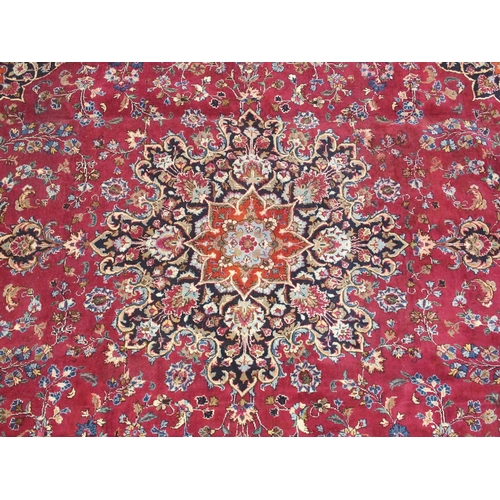 896 - A red ground meshed rug