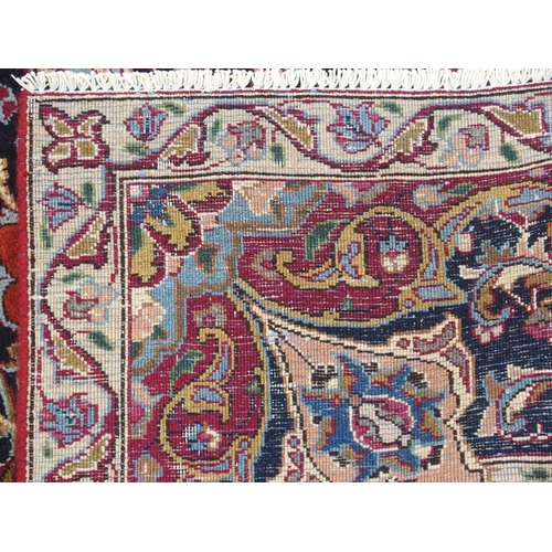 896 - A red ground meshed rug