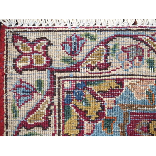 896 - A red ground meshed rug