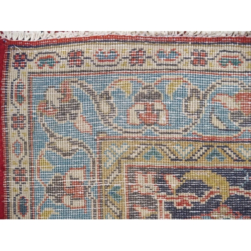 898 - A red ground Sarough rug