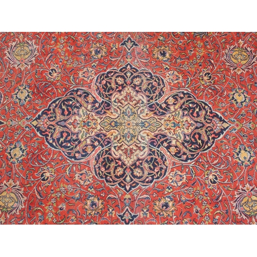 899 - A red ground Sarough rug