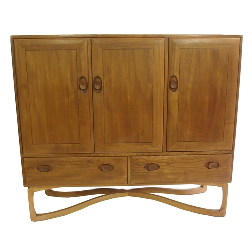 909 - A light Ercol sideboard on a cross stand