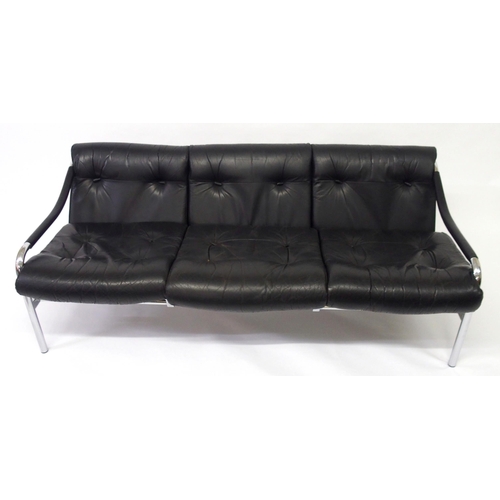 917A - A black leather and chrome Pirelli three seater sofa