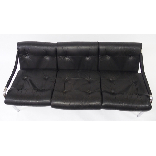 917A - A black leather and chrome Pirelli three seater sofa