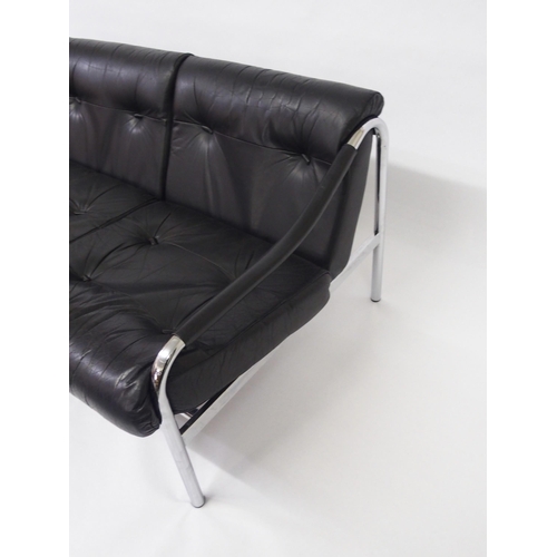 917A - A black leather and chrome Pirelli three seater sofa