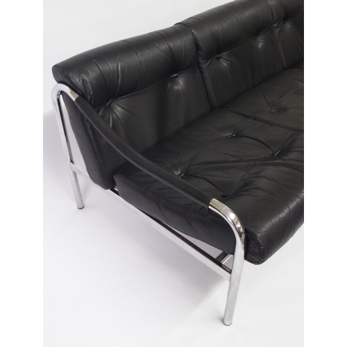 917A - A black leather and chrome Pirelli three seater sofa