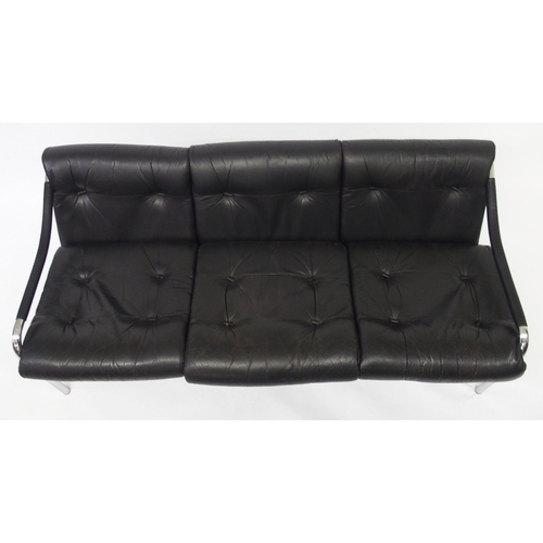 917A - A black leather and chrome Pirelli three seater sofa