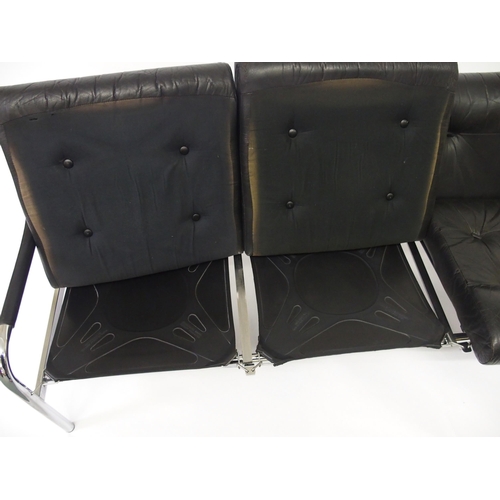 917A - A black leather and chrome Pirelli three seater sofa