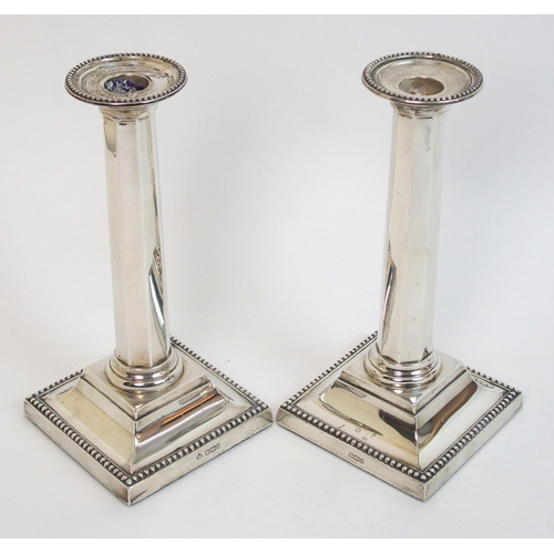 130 - A pair of silver candlesticks