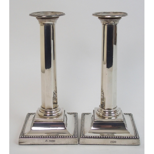 130 - A pair of silver candlesticks