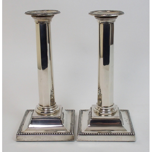 130 - A pair of silver candlesticks