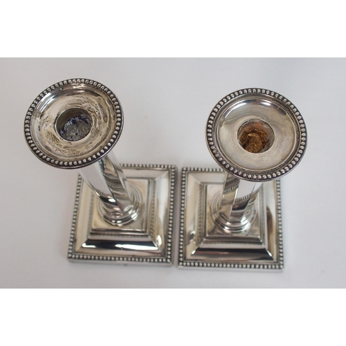 130 - A pair of silver candlesticks