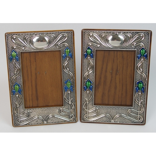 153 - A matched pair of Art Nouveau silver mounted photo frames