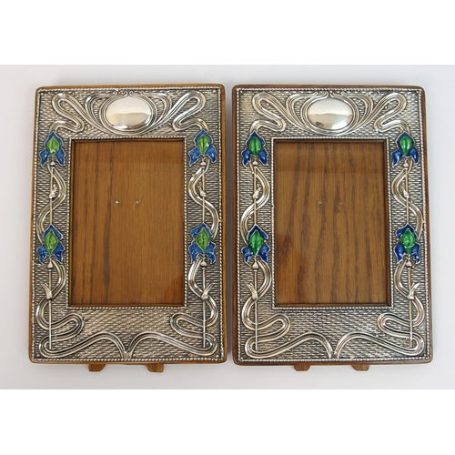 153 - A matched pair of Art Nouveau silver mounted photo frames