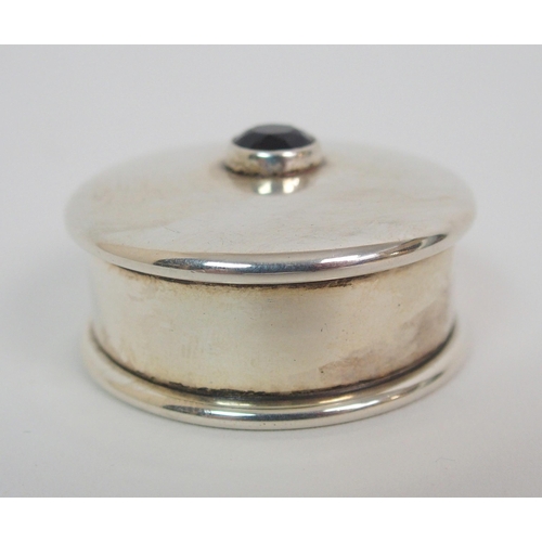 179 - A silver circular pill box with gem set lid