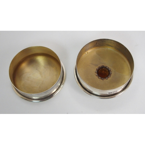 179 - A silver circular pill box with gem set lid
