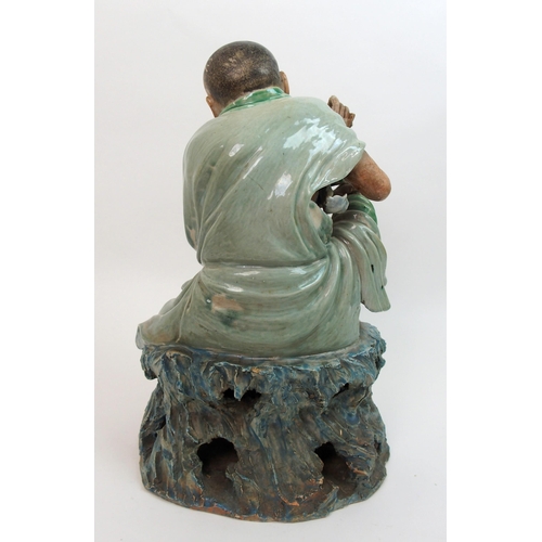 23 - A Chinese ceramic sculpture of a Taoist monk and serpent