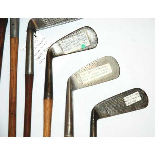 375 - A collection of fourteen various hickory-shafted putters and irons