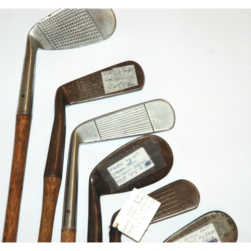 375 - A collection of fourteen various hickory-shafted putters and irons