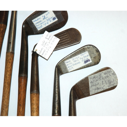 375 - A collection of fourteen various hickory-shafted putters and irons