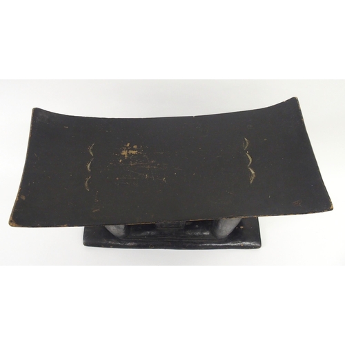 40 - An African carved and ebonised stool