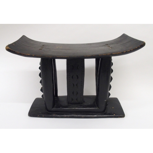 40 - An African carved and ebonised stool