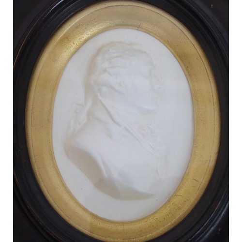 480 - A framed Wedgwood blue jasper plaque depicting a portrait of John Wesley