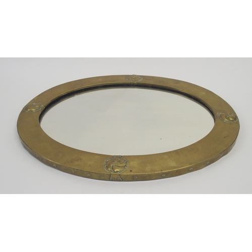 484 - A Liberty design Arts and Crafts brass framed mirror