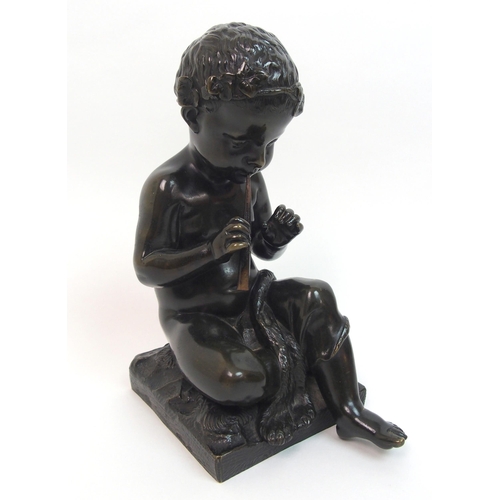 493 - A 20th Century bronze of a small boy playing a pipe