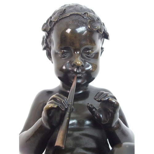 493 - A 20th Century bronze of a small boy playing a pipe